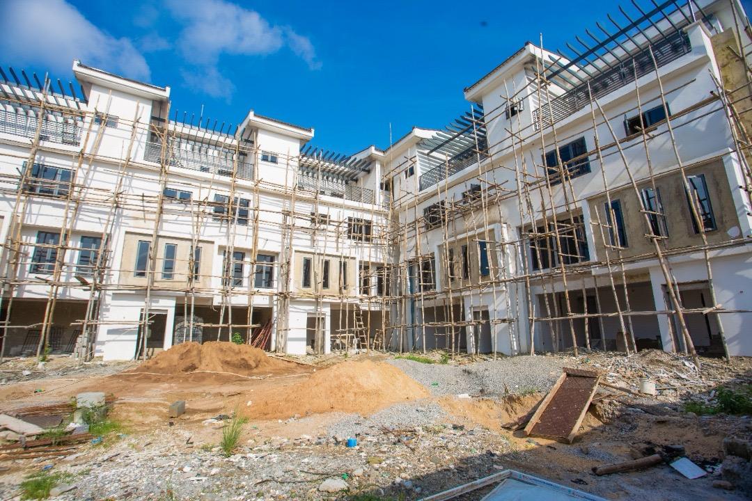Full frontal elevation of The Ivory terrace row under construction, scaffolding across the front